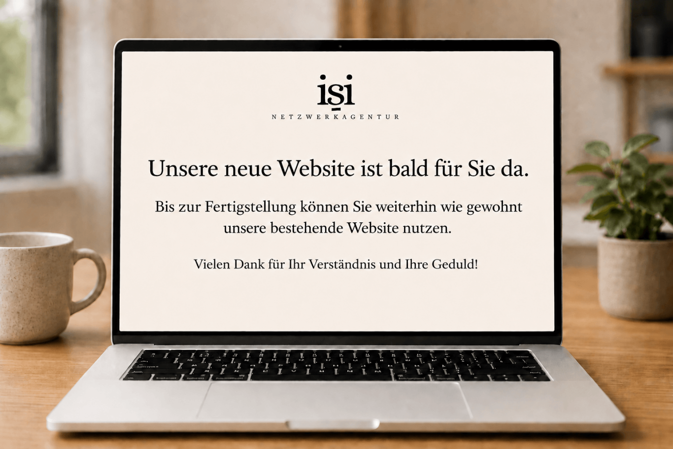 Neue Website wird auf einem Laptop mit einem Text angekündigt. Die bestehende Website kann weiterhin genutzt werden.